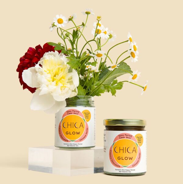 Jar of Chica Glow filled with flowers, next to full jar of Chica Glow.